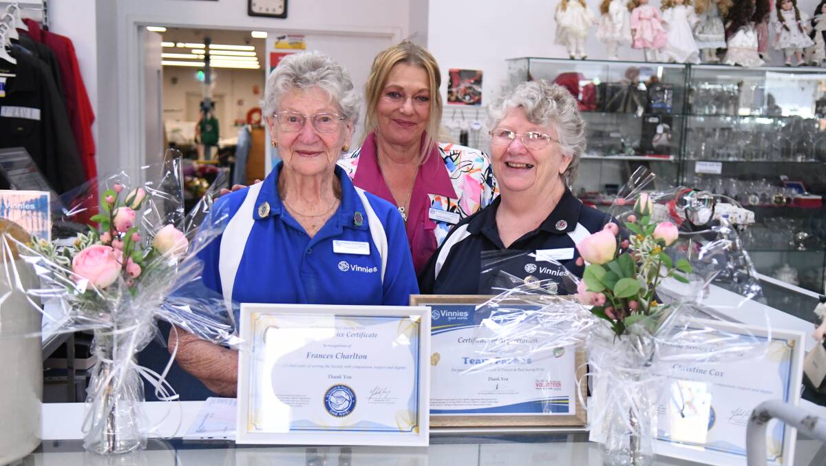 Mother and daughter volunteering team Francis Charlton and Christine Cox congratulated by regional manager Tanya Godden. 