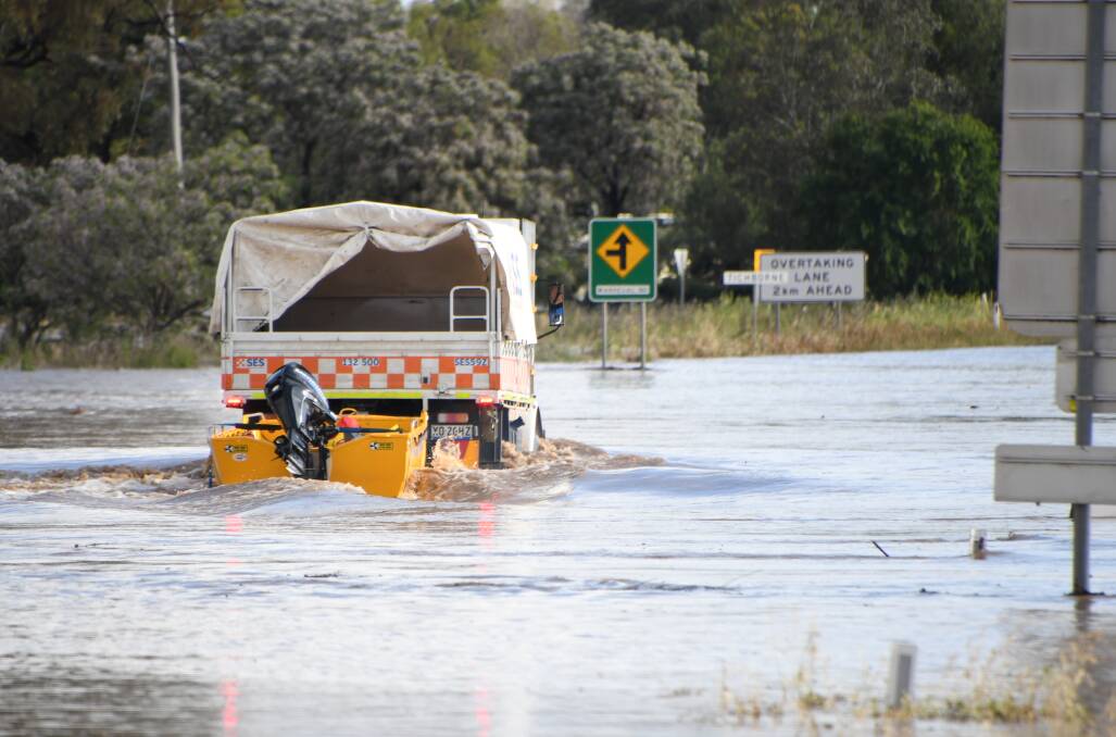 The State Emergency Service heading into floodwaters at Tichborne on November 14, 2022. 