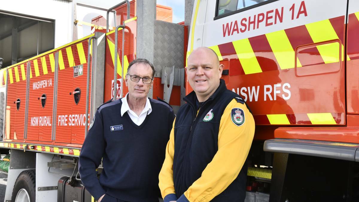 Rural Fire Service Canobolas Zone district manager Brett Bowden and operations manager Luke Crotty with one of the RFS fire trucks. Picture by Carla Freedman