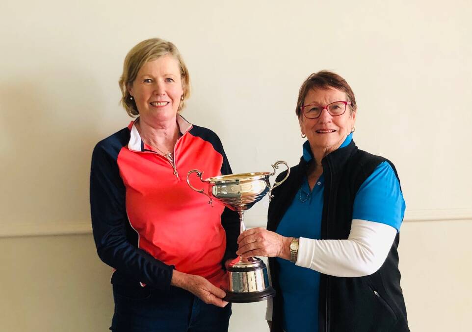 Anita Medcalf and Col Flynn with their trophy after winning the ladies foursomes championships on Saturday. Photo: CONTRIBUTED