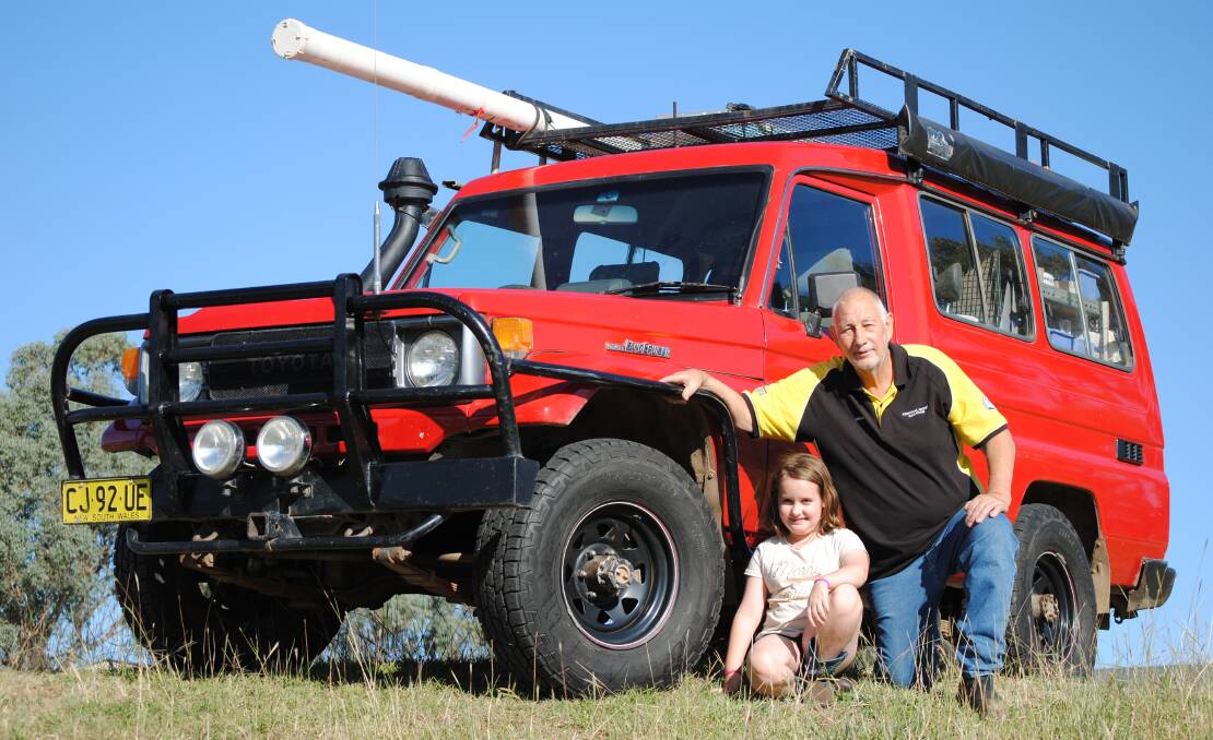 Dick Jefferay and his granddaughter Ava Jefferay with his work horse, a 1992 Toyota Landcruiser Troop carrier RV, that he'll never sell. Instead it'll be passed down. Picture by Jeff McClurg