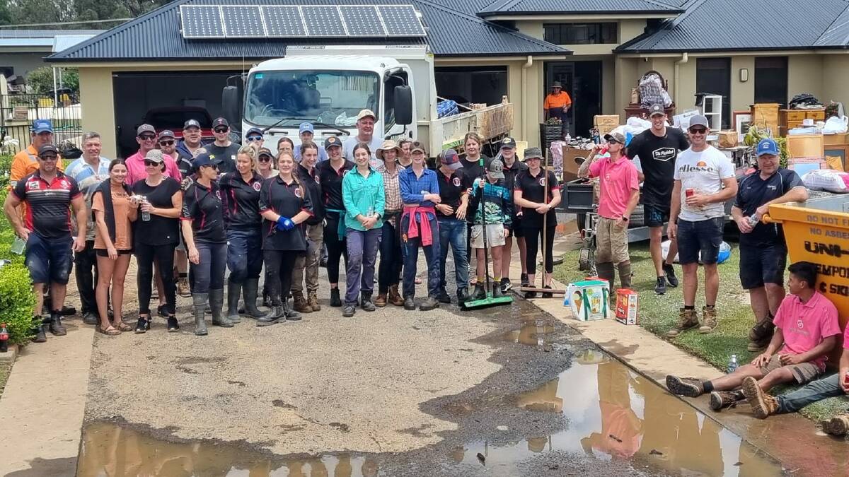 Dooley Thomson (in the pink shirt on the left) with his band of volunteers in Davids Lane, Parkes, helping to clean up after major flooding along Billabong Creek. Picture supplied